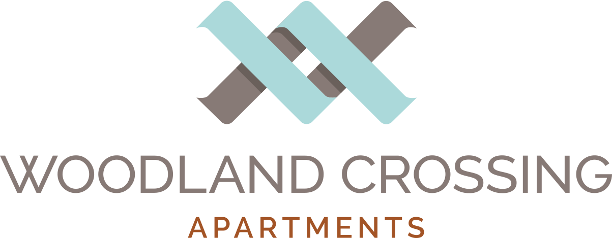 the logo for woodlands crossing apartments with the words woodland crossing apartments at Woodland Crossing , California, 95695